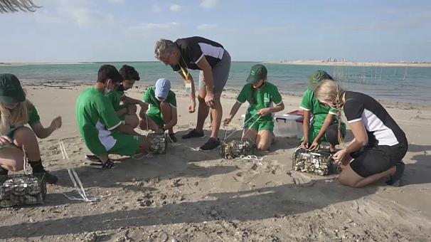 Students building artificial reef